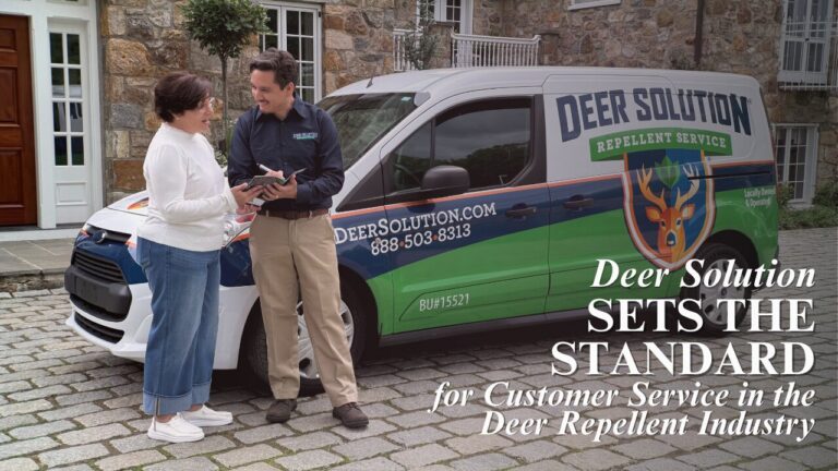 A Deer Solution representative providing professional consultation to a homeowner next to a branded service van.