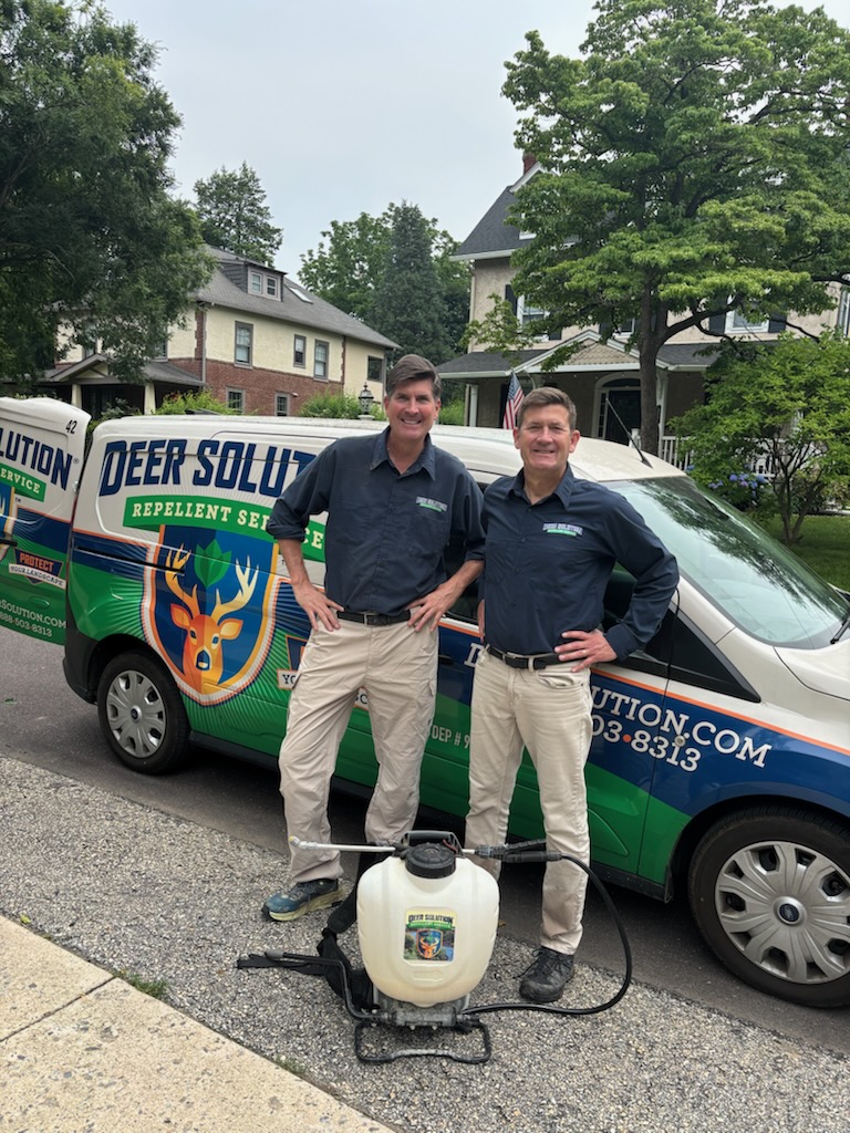 Two Deer Solution of the Main Line team members standing beside a service van.